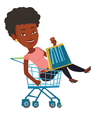 Image showing Happy woman riding by shopping trolley.