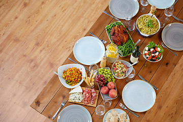 Image showing various food on served wooden table