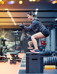 Image showing woman doing squats on pnatfom in gym