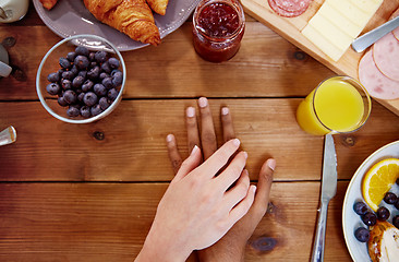 Image showing couple hands on table full of food