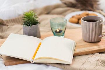 Image showing diary, tea and candle in holder at home