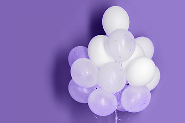 Image showing white helium balloons on ultra violet background