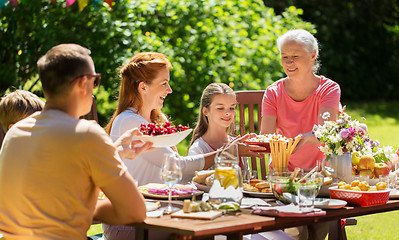 Image showing happy family having dinner or summer garden party