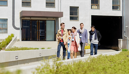 Image showing office workers with coffee walking in city