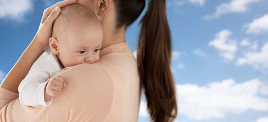 Image showing close up of little baby boy with mother over sky