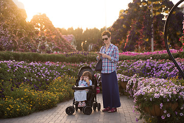 Image showing mother and daughter in flower garden