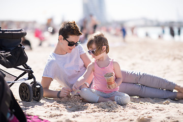 Image showing Mom and daughter on the beach