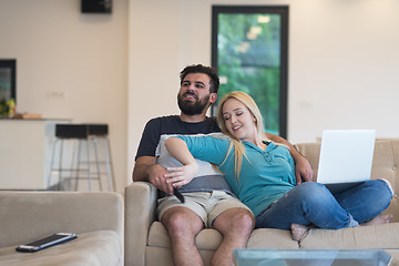 Image showing young happy couple relaxes in the living room