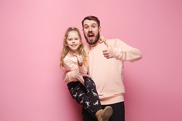 Image showing Young father with his baby daughter with thumb up