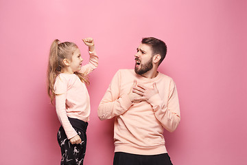 Image showing Young father with his baby daughter. The kid in preschool age pointing with finger