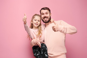 Image showing Young father with his baby daughter with thumb up