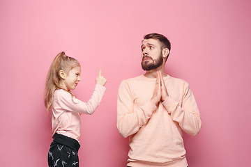 Image showing Young father with his baby daughter. The kid in preschool age pointing with finger