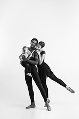 Image showing A happy family of ballet dancers on white studio background