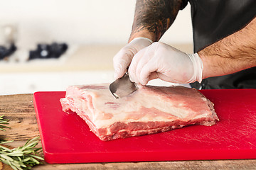 Image showing Man cooking meat steak on kitchen