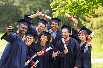 Image showing students or graduates with diplomas taking selfie