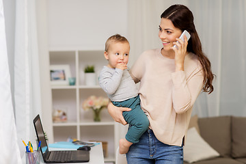 Image showing mother with baby calling on smartphone at home