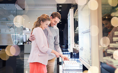 Image showing happy couple choosing engagement ring in mall