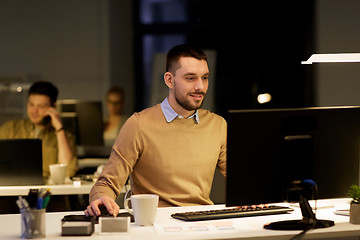 Image showing man with computer working late at night office