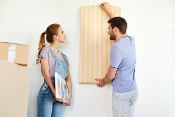 Image showing couple with wallpaper repairing apartment or home