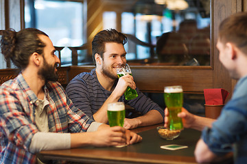 Image showing male friends drinking green beer at bar or pub