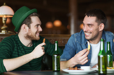 Image showing happy male friends drinking beer at bar or pub