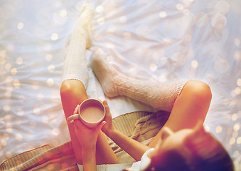 Image showing close up of woman with cocoa cup in bed at home