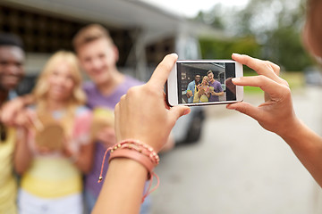 Image showing woman photographing friends eating at food truck