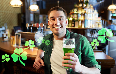 Image showing man drinking green beer at bar or pub