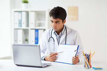 Image showing doctor with laptop and cardiogram at clinic