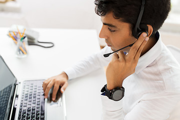 Image showing businessman with headset and laptop at office