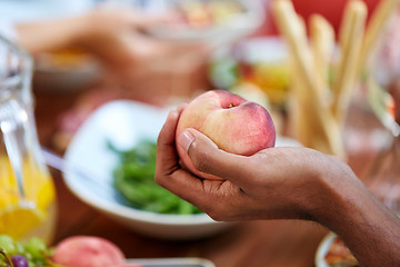 Image showing male hand holding peach
