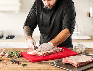 Image showing Man cooking meat steak on kitchen