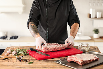 Image showing Man cooking meat steak on kitchen