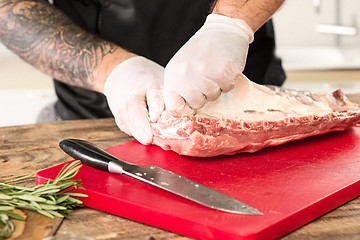 Image showing Man cooking meat steak on kitchen