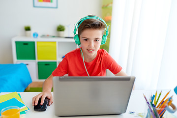 Image showing boy in headphones playing video game on laptop