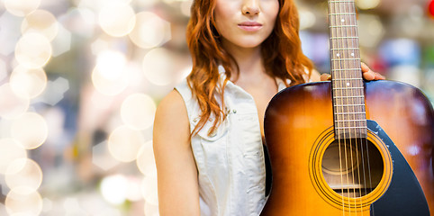 Image showing close up of female musician with guitar