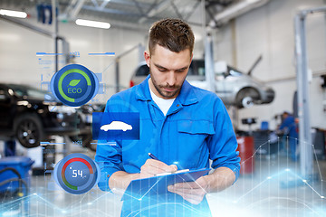 Image showing auto mechanic man with clipboard at car workshop