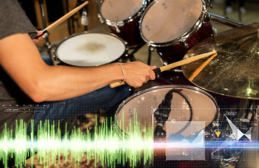 Image showing male musician playing drum kit at concert