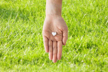 Image showing close up of hand holding medicine heart pill