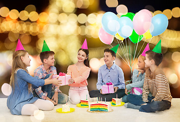 Image showing happy children giving presents at birthday party