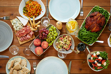 Image showing various food on served wooden table