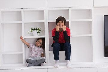 Image showing young boys posing on a shelf