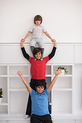 Image showing young boys posing line up piggyback