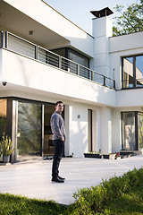 Image showing man in front of his luxury home villa