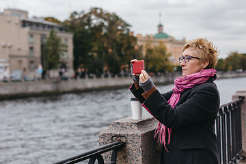 Image showing Woman taking shots on waterfront