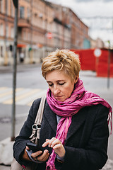 Image showing Woman with phone on city street