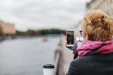 Image showing Woman taking shots from waterfront