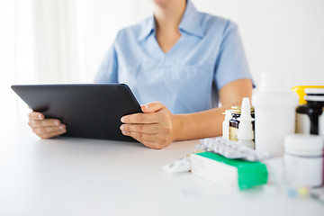 Image showing nurse or doctor with medicines and tablet pc