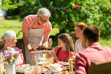 Image showing family having dinner or barbecue at summer garden