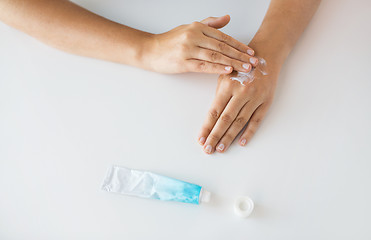 Image showing close up of hands with cream or therapeutic salve